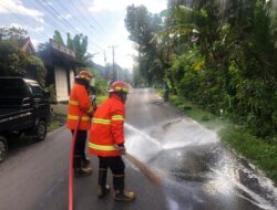 Gercep Damkartan Karangasem Bersihkan Ceceran Solar di Jalan Raya Ababi